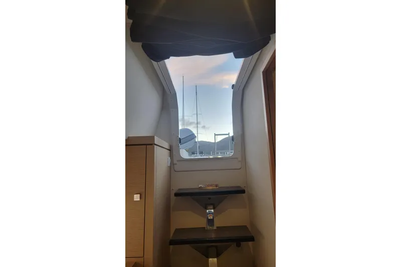 Three Sheets Yacht Photos Pics Interior view of 2019 Fountaine Pajot Saona 47 yacht, featuring stairs and window.