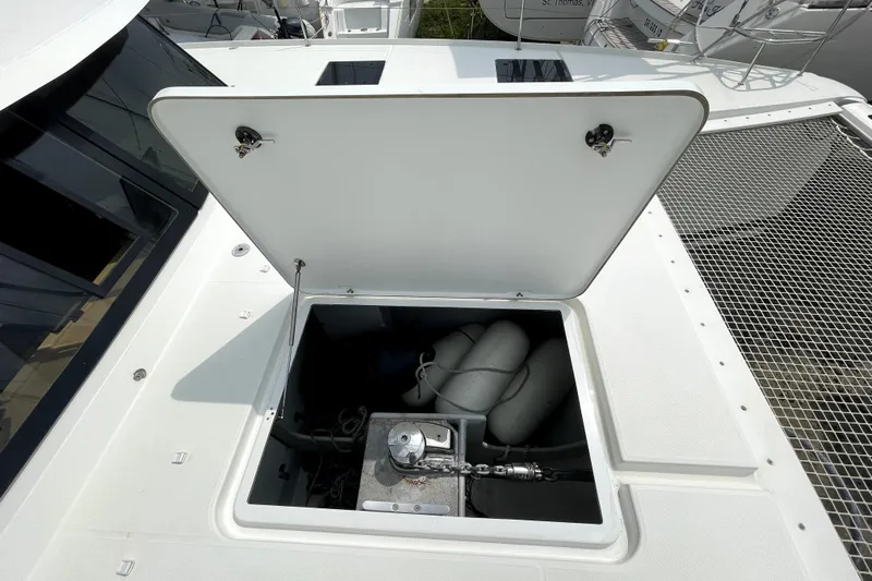 Three Sheets Yacht Photos Pics Open hatch on 2019 Fountaine Pajot Saona 47 catamaran deck, revealing storage compartment.