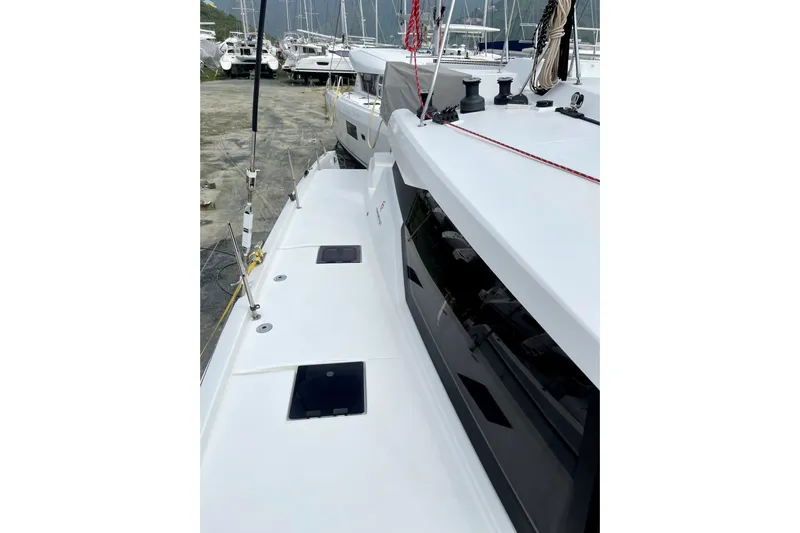 Three Sheets Yacht Photos Pics 2019 Fountaine Pajot Saona 47 catamaran docked, showcasing sleek deck design and modern features.