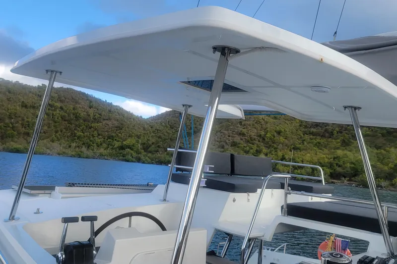 Three Sheets Yacht Photos Pics 2019 Fountaine Pajot Saona 47 catamaran helm with scenic water and hillside view.