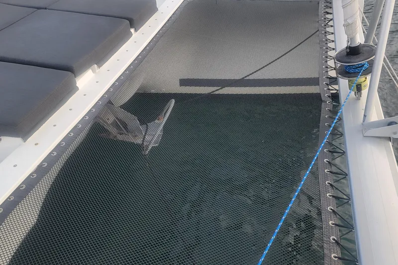 Three Sheets Yacht Photos Pics 2019 Fountaine Pajot Saona 47 catamaran deck with netting and seating.