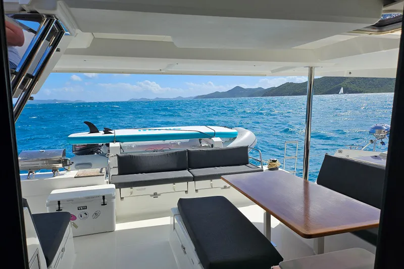 Three Sheets Yacht Photos Pics 2019 Fountaine Pajot Saona 47 yacht interior with ocean view and seating area.