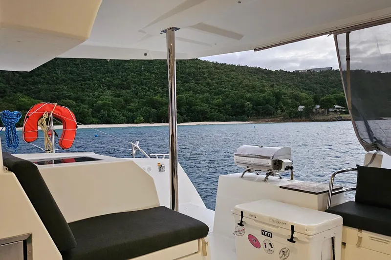 Three Sheets Yacht Photos Pics 2019 Fountaine Pajot Saona 47 catamaran with scenic coastal view and onboard amenities.