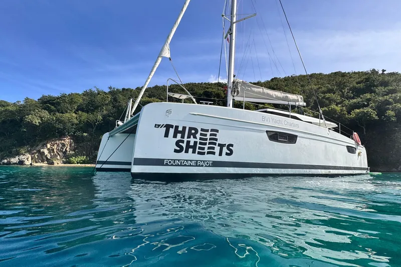 Three Sheets Yacht Photos Pics 2019 Fountaine Pajot Saona 47 catamaran anchored near lush coastline.