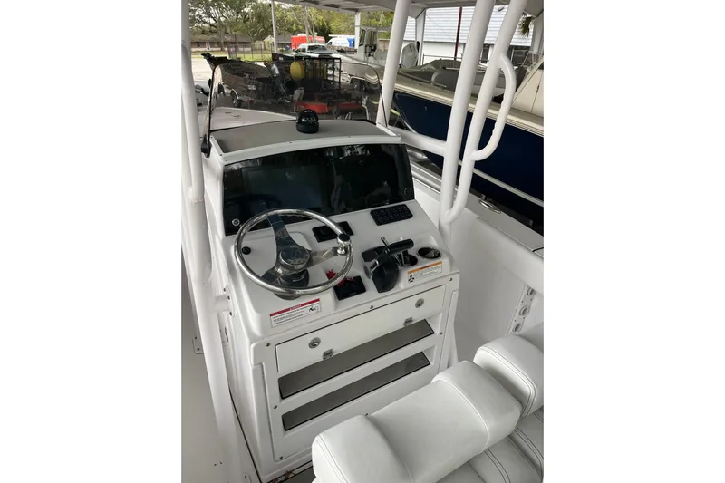  Yacht Photos Pics 2024 Sportsman Open 212 Center Console boat interior with steering wheel and controls.