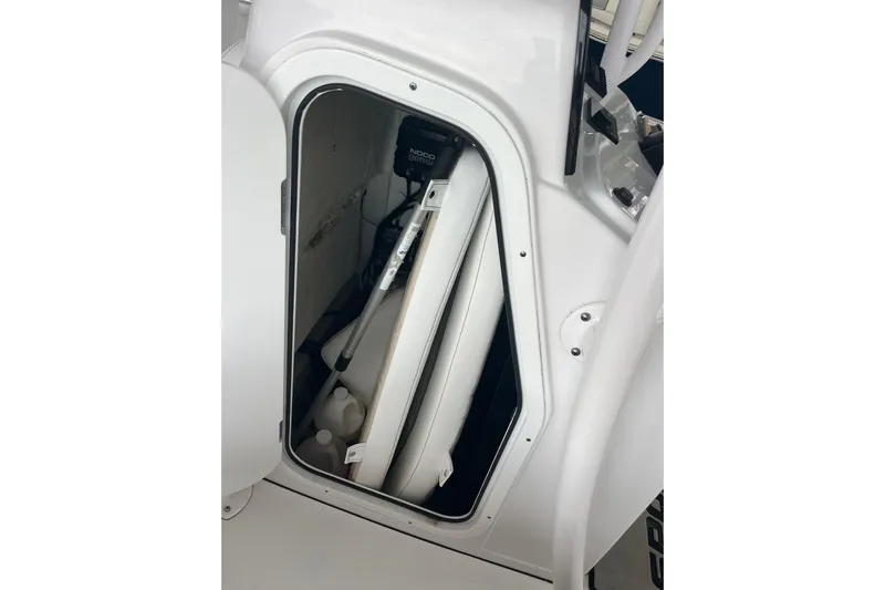  Yacht Photos Pics 2024 Sportsman Open 212 Center Console storage compartment with equipment and supplies.