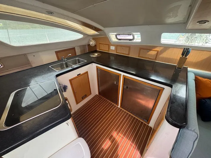 Avatar Yacht Photos Pics Interior of 2010 Admiral 38 Executive yacht kitchen with sleek countertops and wooden cabinetry.