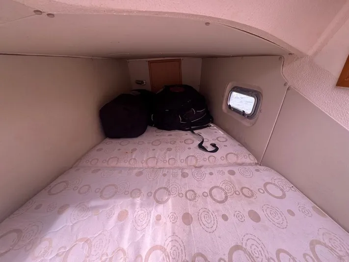 Avatar Yacht Photos Pics Cozy cabin interior of 2010 Admiral 38 Executive yacht with bed and porthole.