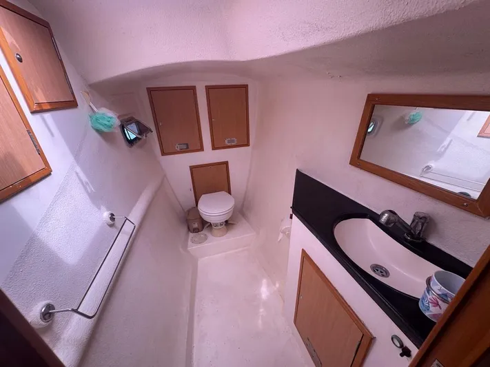 Avatar Yacht Photos Pics Compact bathroom in 2010 Admiral 38 Executive yacht with sink, toilet, and storage cabinets.