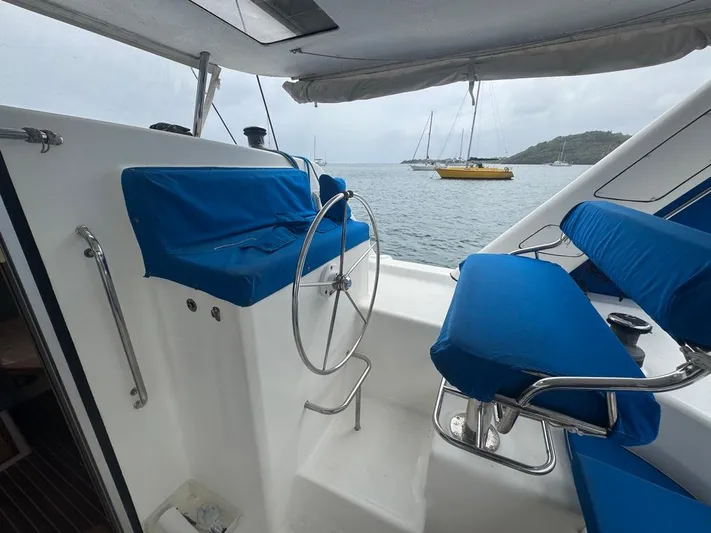 Avatar Yacht Photos Pics 2010 Admiral 38 Executive yacht cockpit with blue seating and steering wheel, overlooking anchored boats.