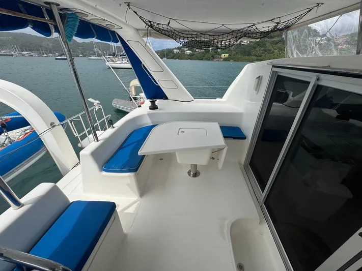 Avatar Yacht Photos Pics 2010 Admiral 38 Executive yacht with blue seating, table, and scenic marina view.