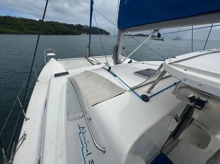 Avatar Yacht Photos Pics Sailing yacht Admiral 38 Executive, 2010 model, on calm waters with lush green shoreline.