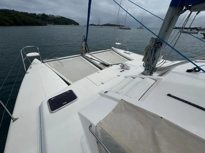 Avatar Yacht Photos Pics 2010 Admiral 38 Executive catamaran on calm waters, featuring spacious deck and netting.