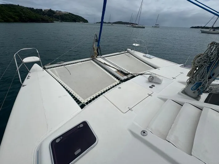 Avatar Yacht Photos Pics 2010 Admiral 38 Executive catamaran deck with netting, moored in a scenic bay.