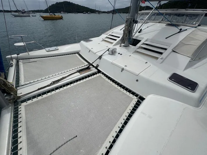 Avatar Yacht Photos Pics 2010 Admiral 38 Executive catamaran with netted deck, anchored in a scenic bay.
