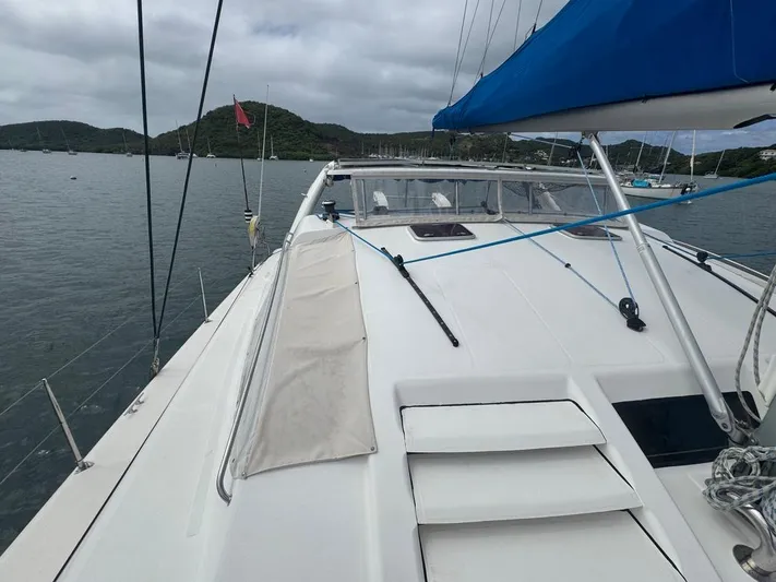 Avatar Yacht Photos Pics Sailing yacht Admiral 38 Executive, 2010 model, on calm waters with blue sail and scenic backdrop.