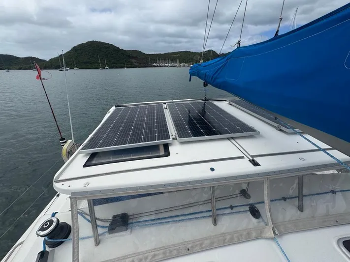 Avatar Yacht Photos Pics Sailboat with solar panels on deck, Admiral 38 Executive, 2010 model, anchored in scenic bay.