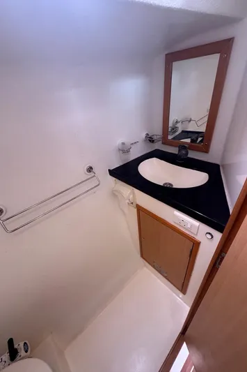 Avatar Yacht Photos Pics Compact bathroom in 2010 Admiral 38 Executive yacht with sink, mirror, and storage.