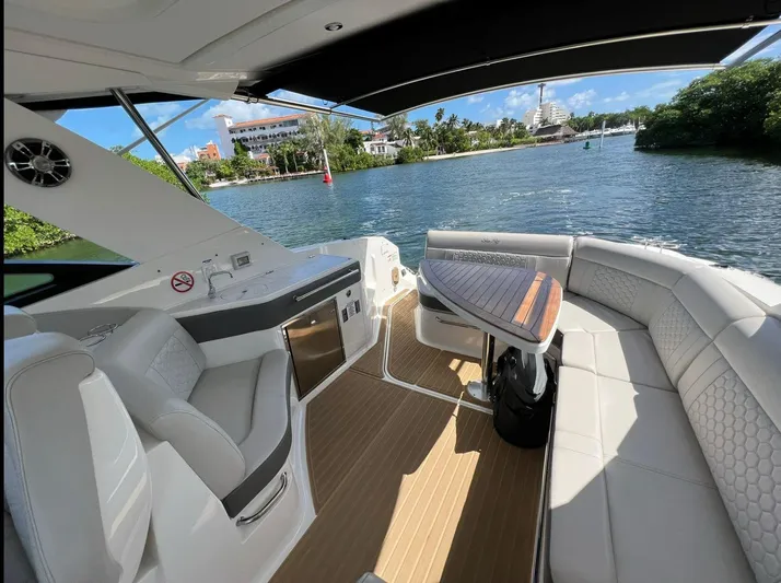 2023 Sea Ray Sundancer 320 @ Cancun Yacht Photos Pics Luxurious 2023 Sea Ray Sundancer 320 yacht interior with elegant seating and scenic water view.