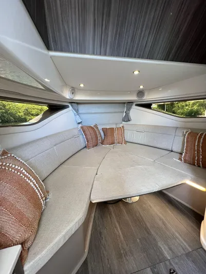 2023 Sea Ray Sundancer 320 @ Cancun Yacht Photos Pics 2023 Sea Ray Sundancer 320 cabin interior with plush seating and decorative pillows.