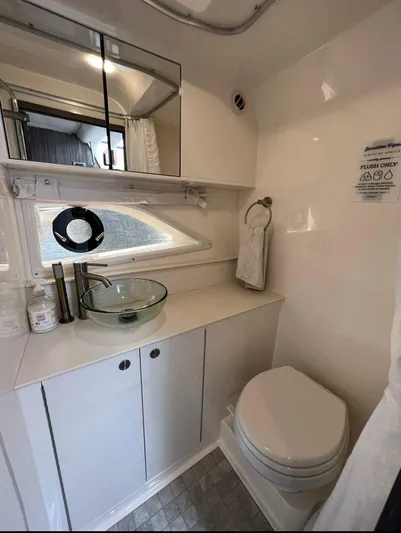 2023 Sea Ray Sundancer 320 @ Cancun Yacht Photos Pics 2023 Sea Ray Sundancer 320 bathroom with modern sink, mirror, and toilet.