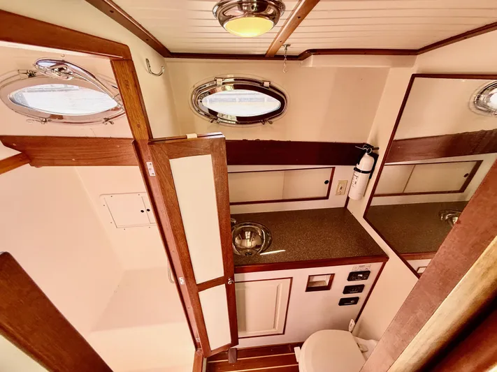  Yacht Photos Pics Interior of 2006 Mast & Mallet Thomas Point 40 boat, featuring wooden cabinetry and porthole windows.