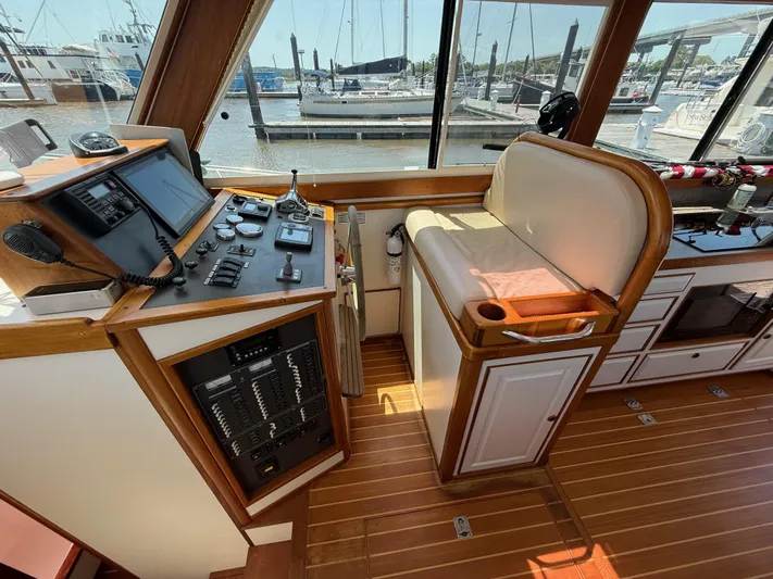  Yacht Photos Pics Interior helm of 2006 Mast & Mallet Thomas Point 40 boat, featuring control panel and seating.