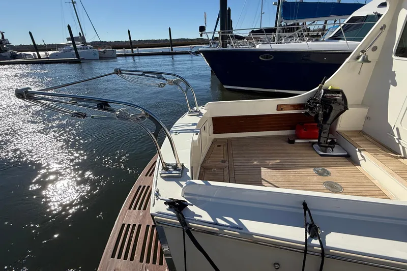  Yacht Photos Pics 2006 Mast & Mallet Thomas Point 40 boat docked, featuring a wooden deck and Mercury outboard motor.