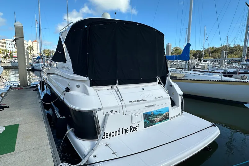 Beyond The Reef Yacht Photos Pics 2008 Regal Commodore 4060 yacht docked at marina, featuring sleek design and covered deck.
