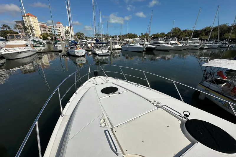 Beyond The Reef Yacht Photos Pics Bow view of 2008 Regal Commodore 4060 yacht docked in a marina with other boats.