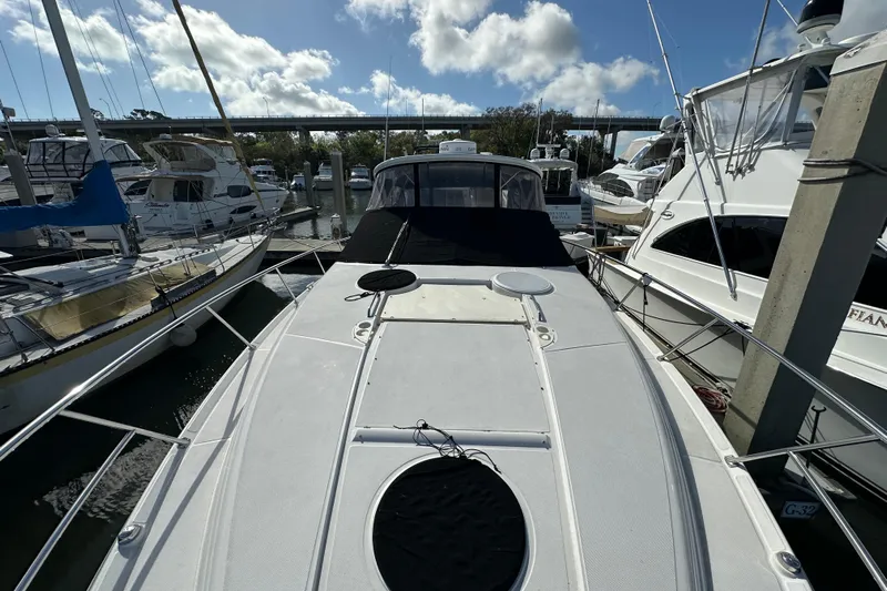 Beyond The Reef Yacht Photos Pics 2008 Regal Commodore 4060 yacht docked at marina under blue sky.