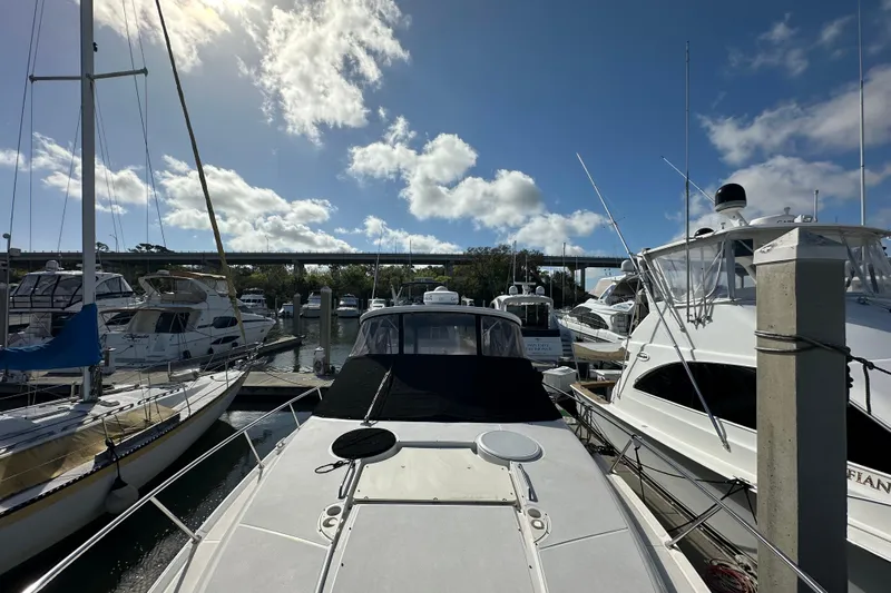 Beyond The Reef Yacht Photos Pics 2008 Regal Commodore 4060 yacht docked at marina under a bright blue sky.