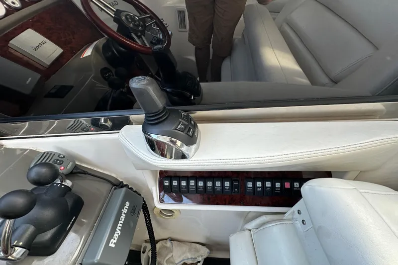 Beyond The Reef Yacht Photos Pics Interior of 2008 Regal Commodore 4060 boat with control panel and steering wheel.