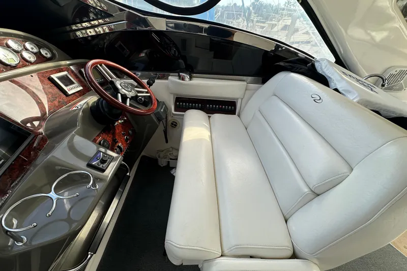 Beyond The Reef Yacht Photos Pics Interior of 2008 Regal Commodore 4060 yacht with white leather seating and wood-accented dashboard.