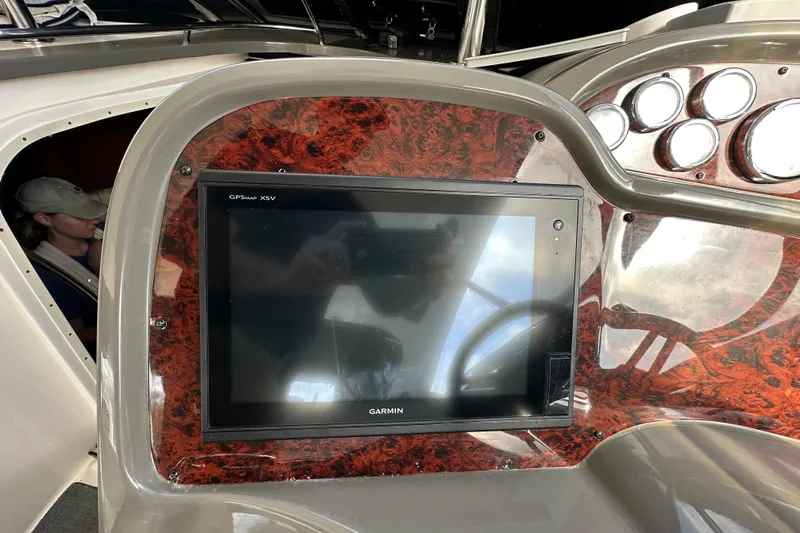 Beyond The Reef Yacht Photos Pics Garmin GPS display on 2008 Regal Commodore 4060 yacht dashboard with wood paneling.