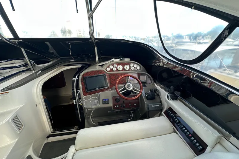 Beyond The Reef Yacht Photos Pics 2008 Regal Commodore 4060 yacht cockpit with steering wheel and navigation controls.