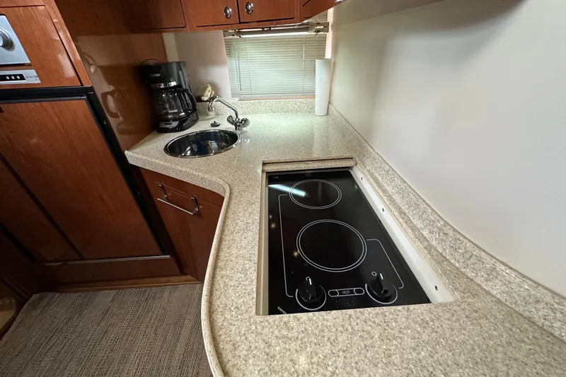 Beyond The Reef Yacht Photos Pics 2008 Regal Commodore 4060 yacht kitchen with stove, sink, and coffee maker.