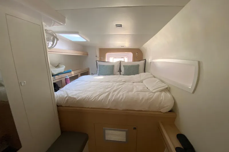 Inky Blue Yacht Photos Pics Cozy cabin interior of 2018 Outremer 51 yacht with bed and storage.