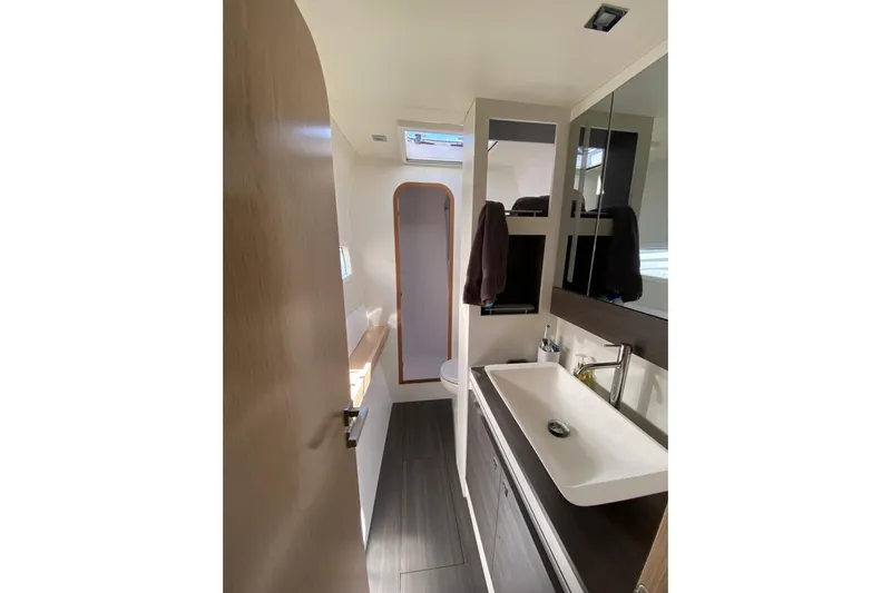 Inky Blue Yacht Photos Pics Modern bathroom interior of 2018 Outremer 51 yacht, featuring sleek design and ample lighting.
