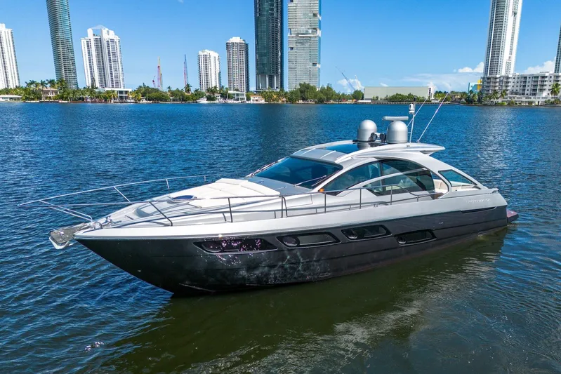 Two Bite Yacht Photos Pics 2018 Pershing 5x yacht on water with city skyline background.