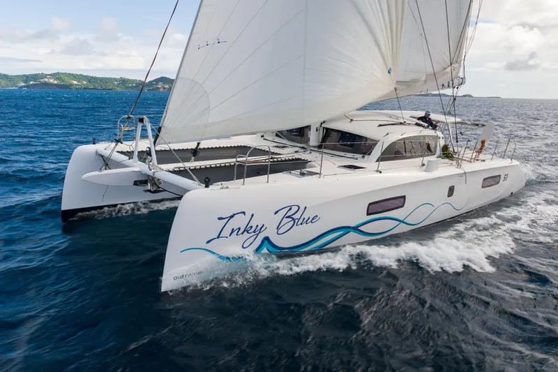 Inky Blue Yacht Photos Pics Outremer 51 catamaran sailing on open sea, 2020 model, named "Inky Blue".