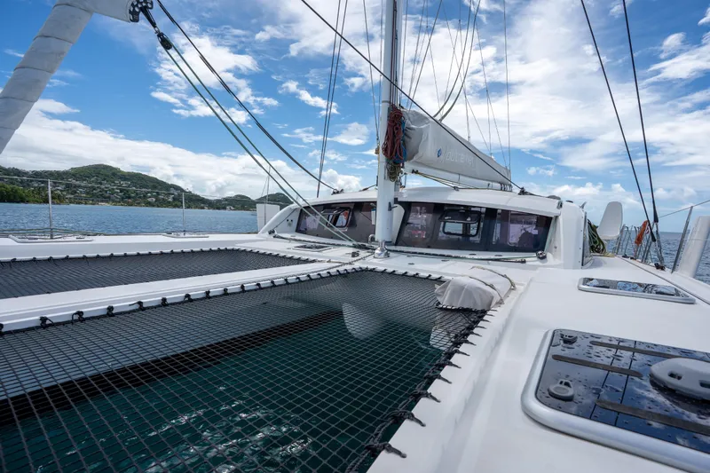 Inky Blue Yacht Photos Pics 2020 Outremer 51 catamaran on water, showcasing deck and rigging under blue sky.
