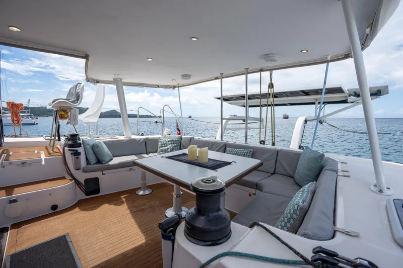Inky Blue Yacht Photos Pics Spacious deck of 2020 Outremer 51 catamaran with seating, table, and ocean view.