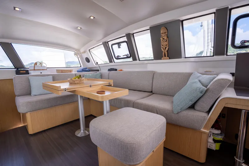 Inky Blue Yacht Photos Pics Luxurious interior of 2020 Outremer 51 catamaran with modern seating and dining area.
