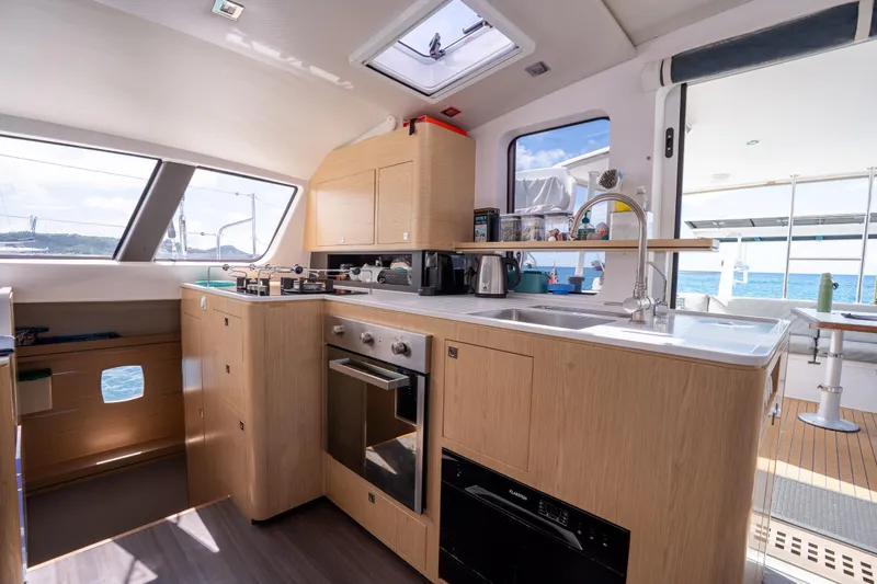Inky Blue Yacht Photos Pics Modern kitchen interior of 2020 Outremer 51 catamaran with ocean view.