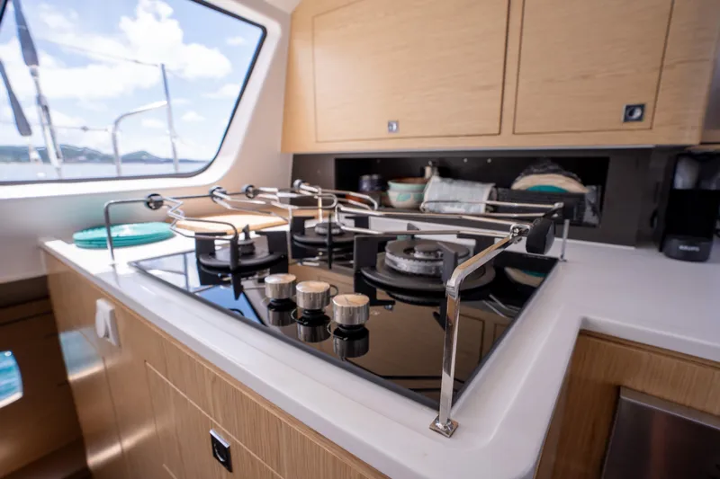 Inky Blue Yacht Photos Pics Modern kitchen in 2020 Outremer 51 yacht with sleek stove and cabinetry.