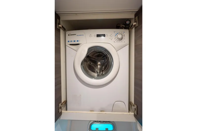 Inky Blue Yacht Photos Pics Washing machine inside 2020 Outremer 51 yacht cabinet, compact and efficient design.