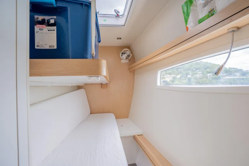Inky Blue Yacht Photos Pics 2020 Outremer 51 interior cabin with bed, storage, and window view.