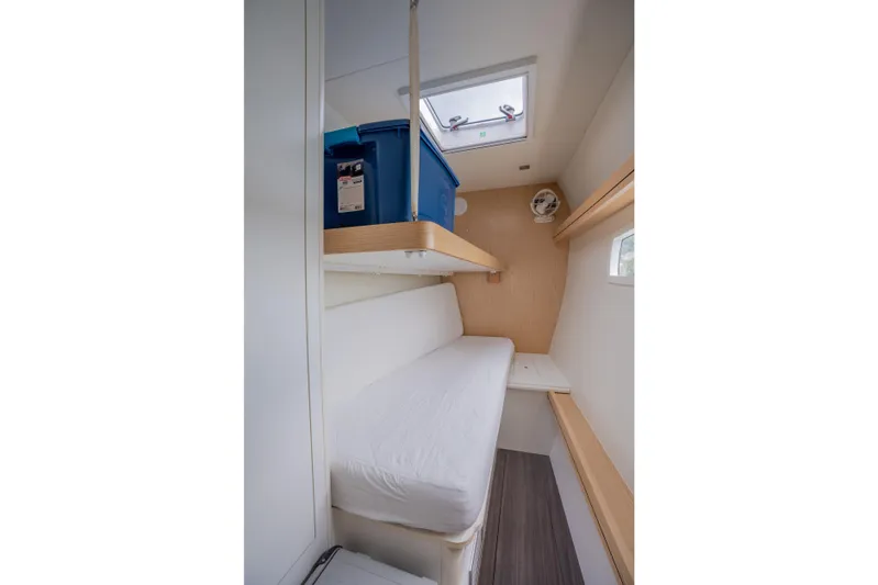 Inky Blue Yacht Photos Pics Interior cabin of 2020 Outremer 51 sailboat, featuring a bed and storage space.