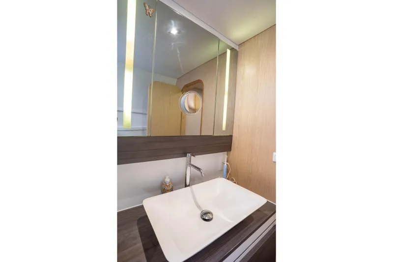 Inky Blue Yacht Photos Pics Modern bathroom sink in 2020 Outremer 51 yacht, featuring sleek design and mirrored cabinet.